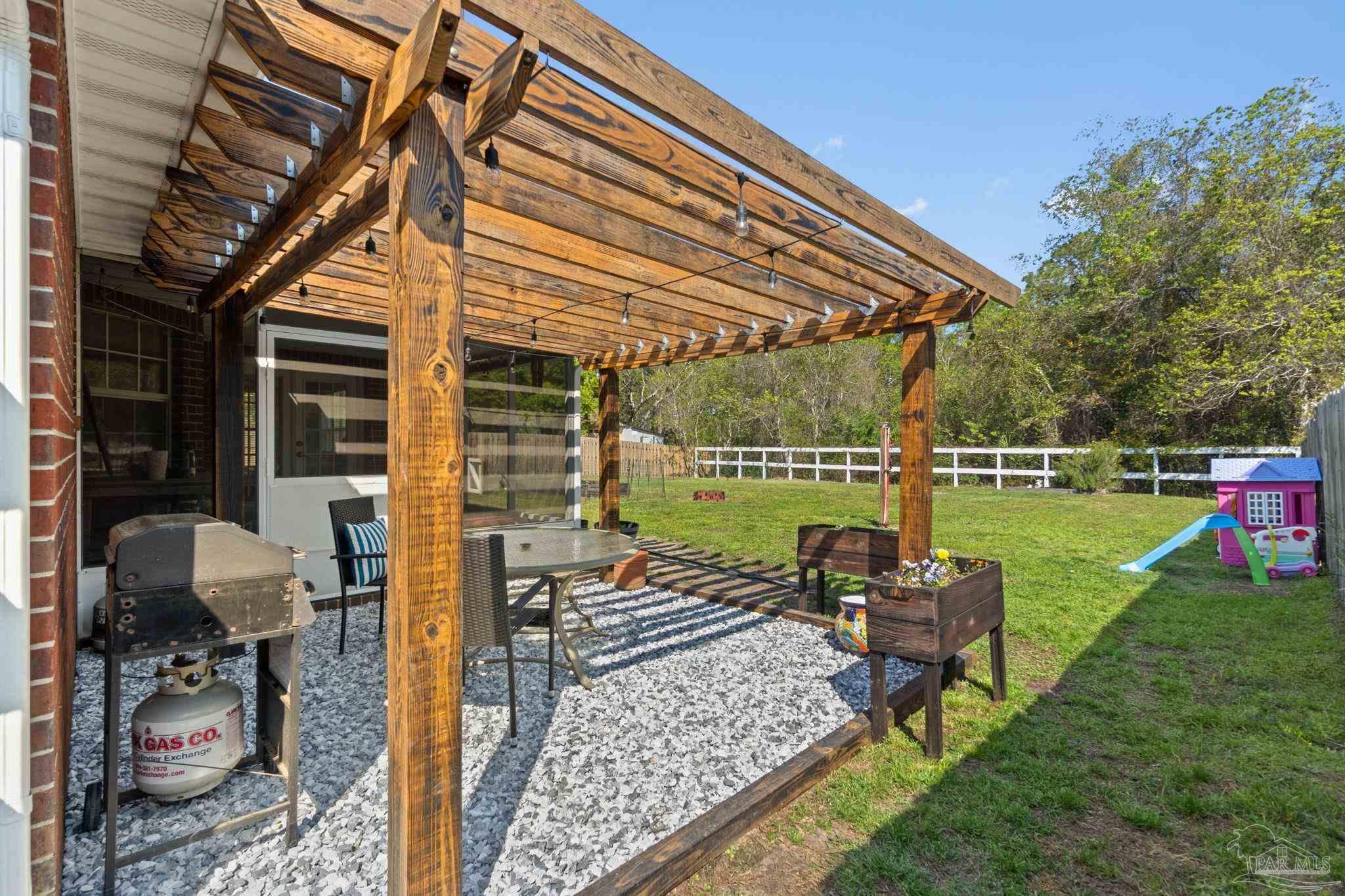 8046 Castle Pointe Way Pensacola, FL 32506 - Photo 28 of 40 a patio with table and chairs and a barbeque