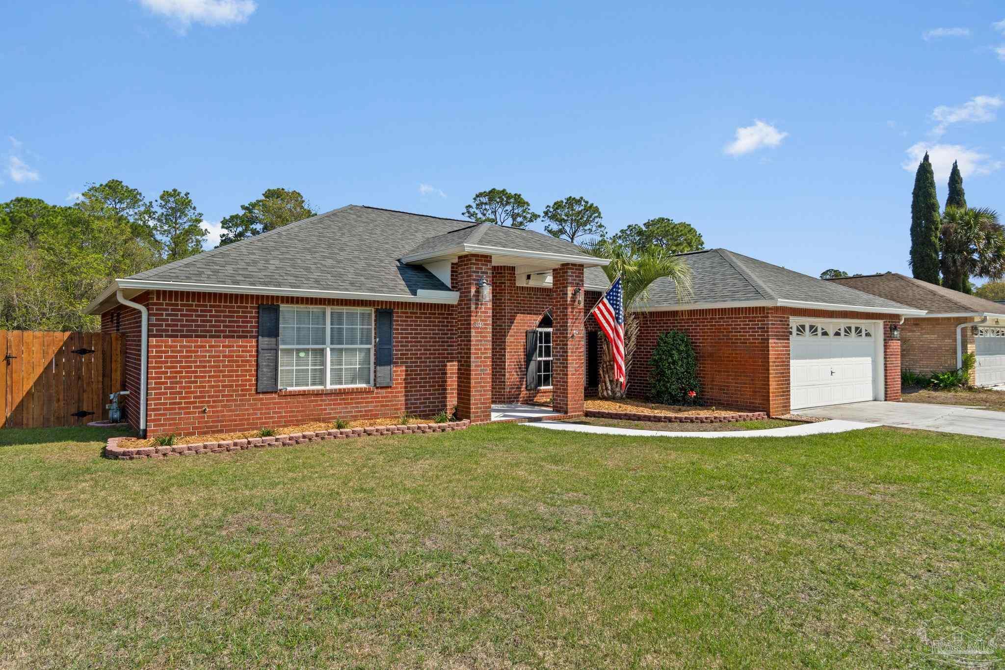8046 Castle Pointe Way Pensacola, FL 32506 - Photo 4 of 40 a front view of a house with a yard