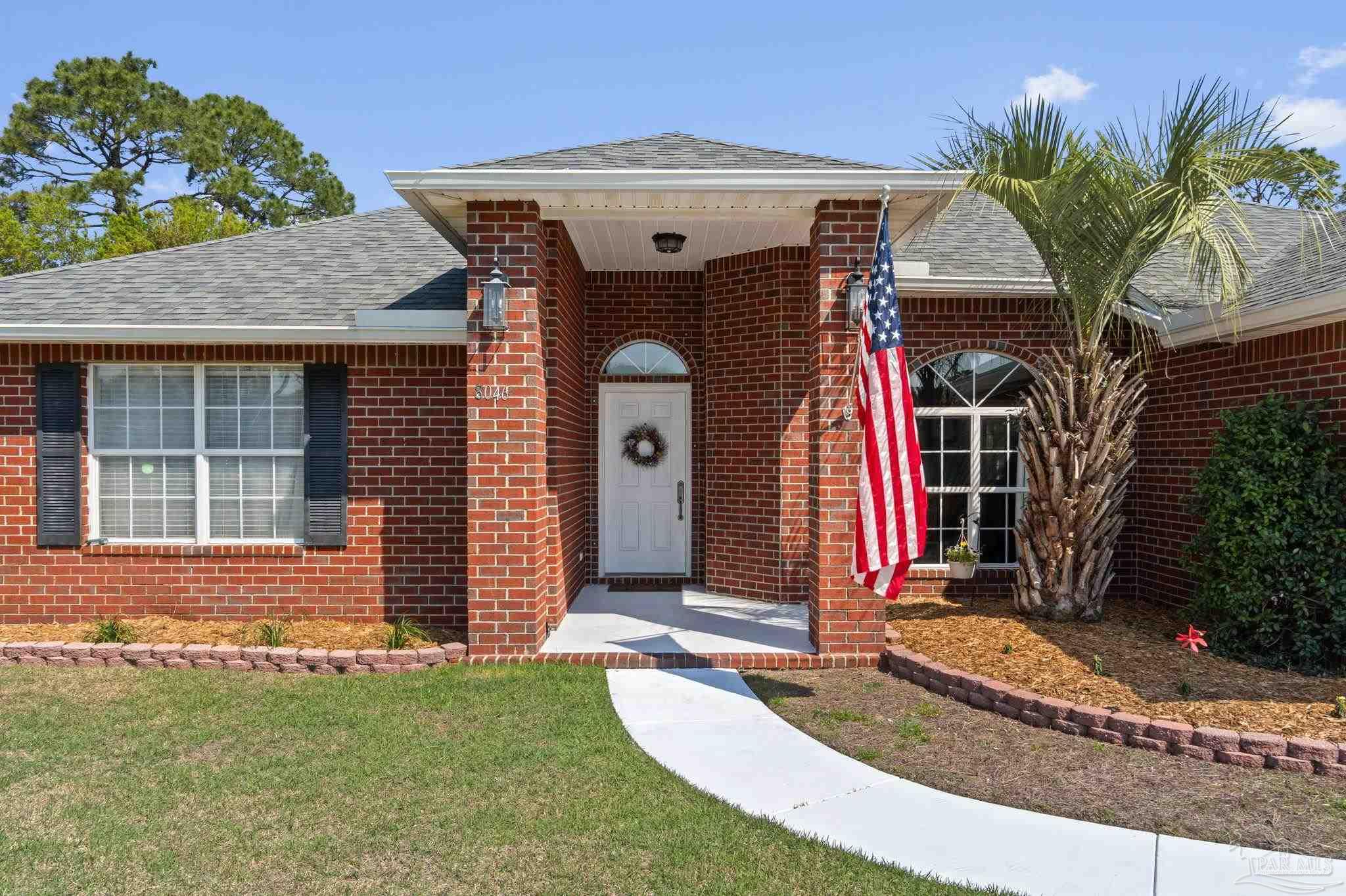 8046 Castle Pointe Way Pensacola, FL 32506 - Photo 5 of 40 a front view of a house with a yard