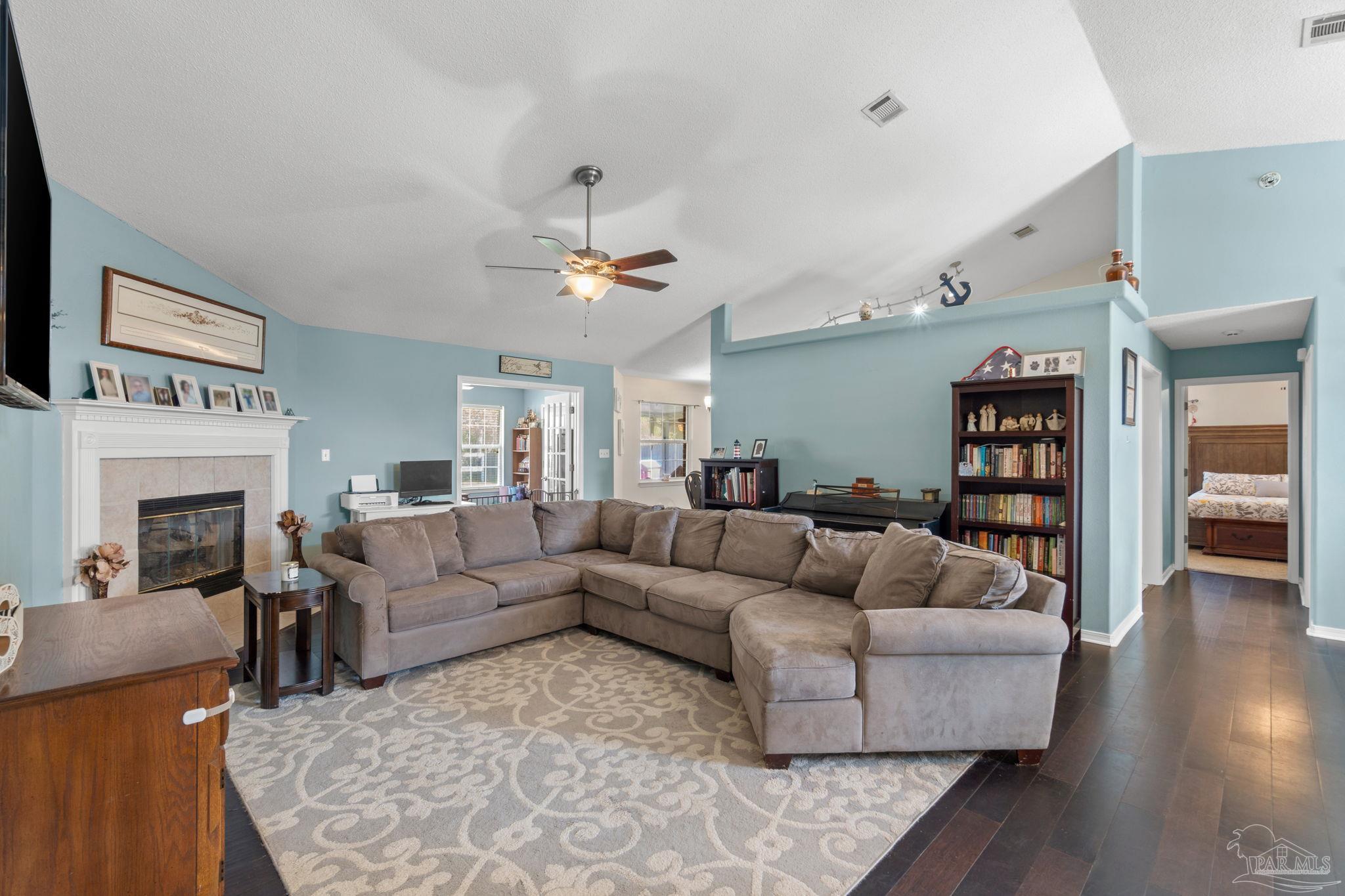 8046 Castle Pointe Way Pensacola, FL 32506 - Photo 7 of 40 a living room with furniture and a fireplace