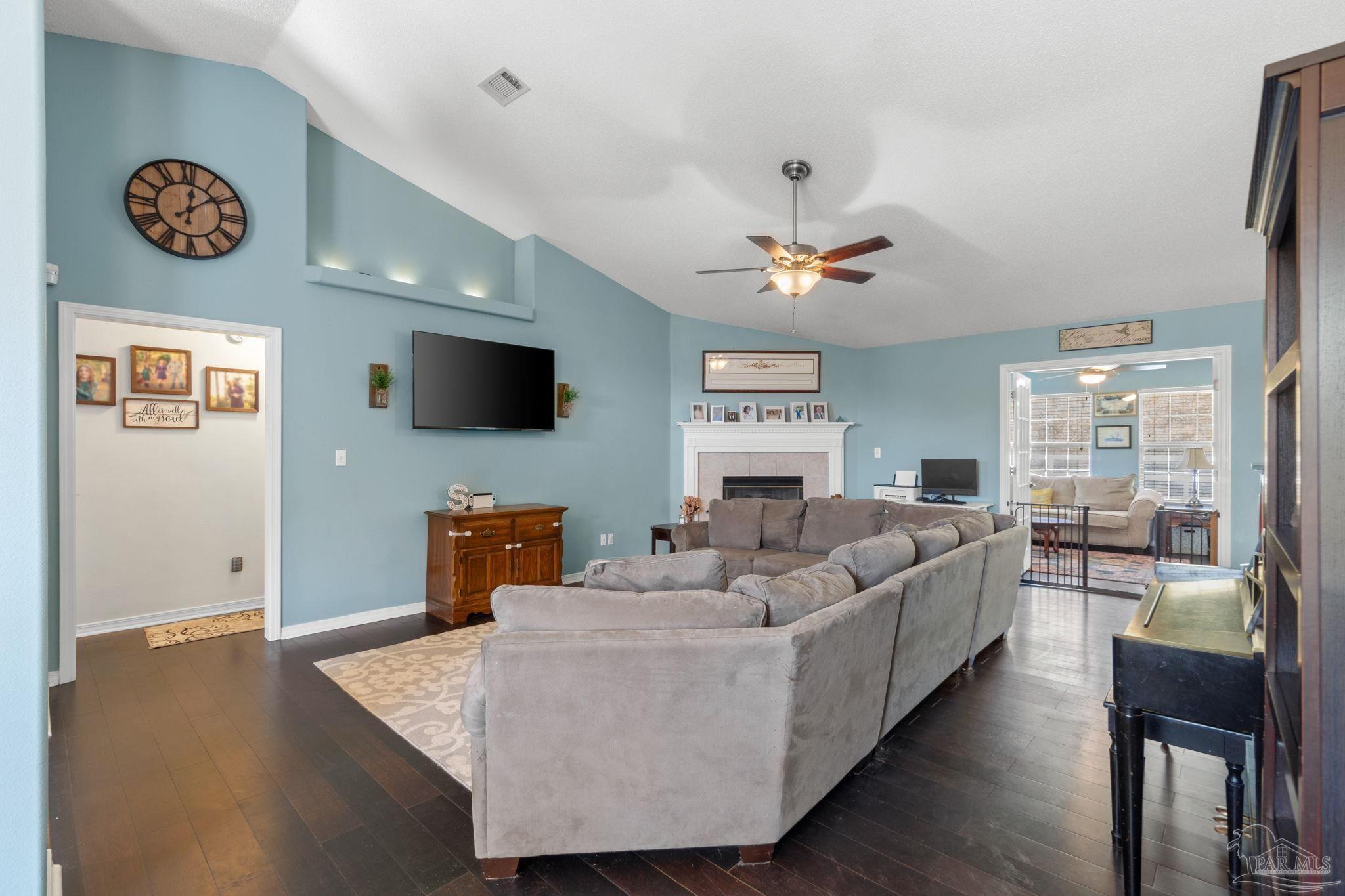 8046 Castle Pointe Way Pensacola, FL 32506 - Photo 8 of 40 a living room with furniture and a flat screen tv