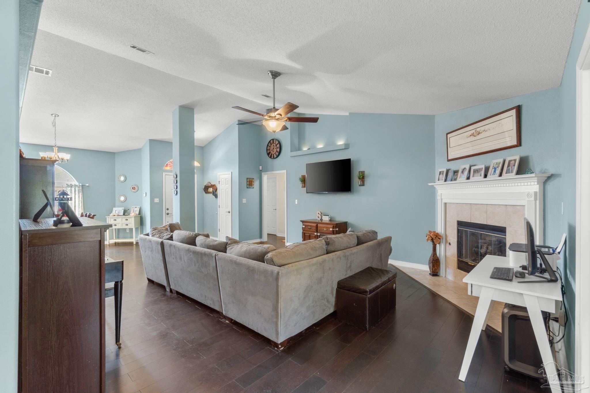 8046 Castle Pointe Way Pensacola, FL 32506 - Photo 9 of 40 a living room with furniture and a fireplace