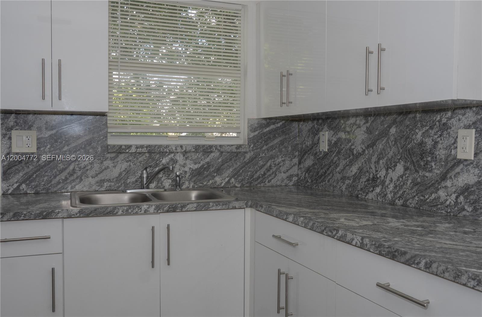 3376 Northwest 49th Street Miami, FL 33142 - Photo 11 of 17 a kitchen with granite countertop white cabinets and a granite counter tops