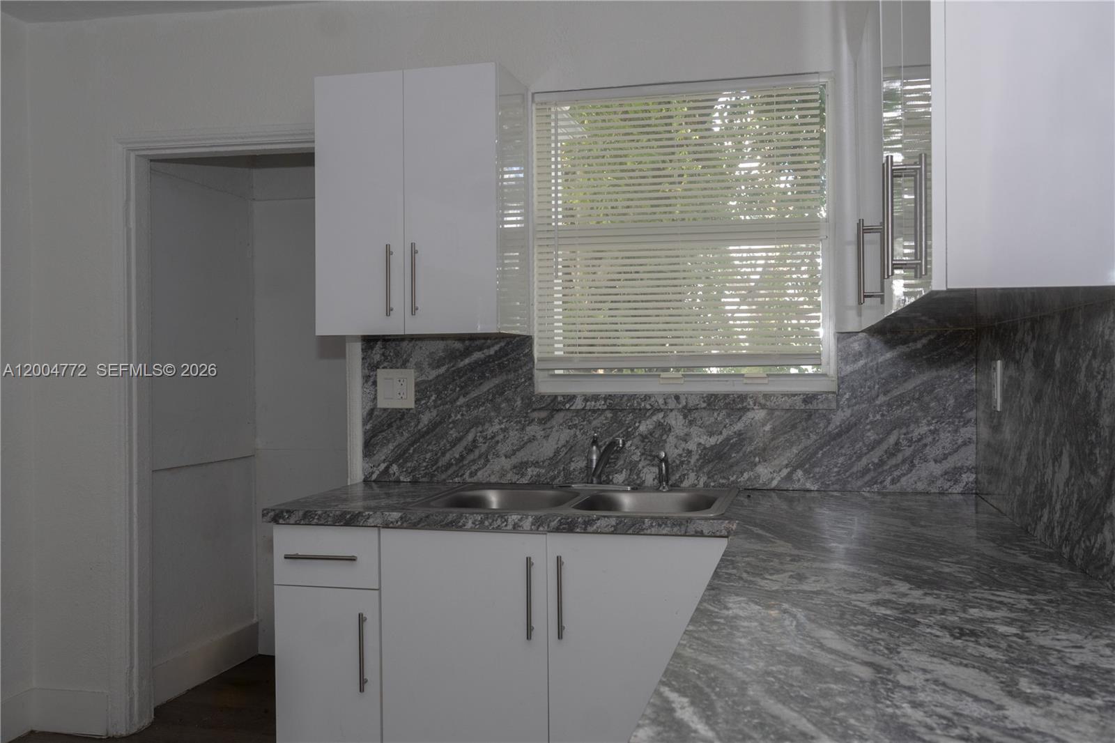 3376 Northwest 49th Street Miami, FL 33142 - Photo 12 of 17 a view of kitchen with granite countertop window