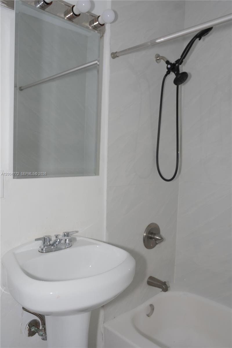 3376 Northwest 49th Street Miami, FL 33142 - Photo 16 of 17 a bathroom with a sink a toilet and a shower