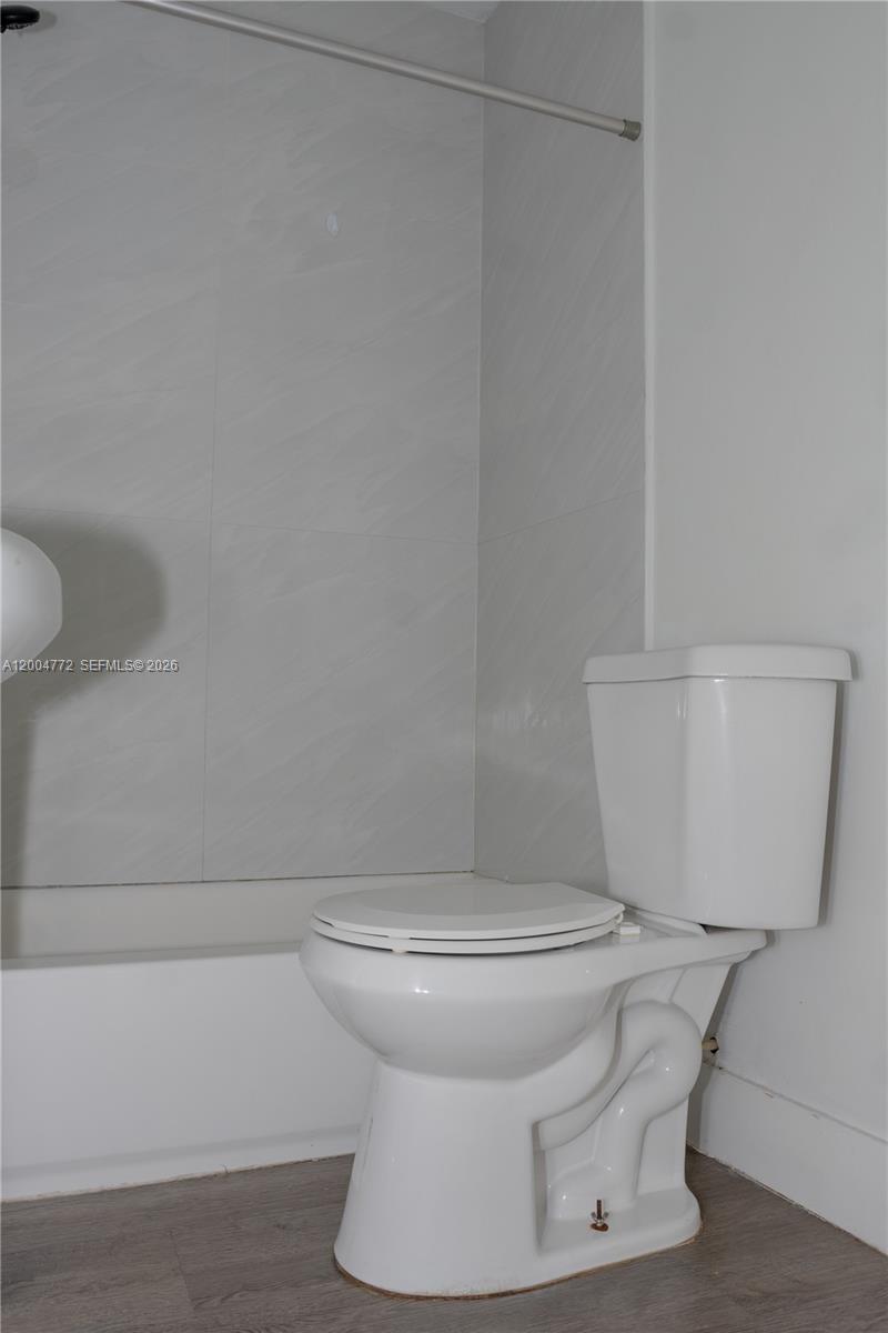3376 Northwest 49th Street Miami, FL 33142 - Photo 17 of 17 a white toilet sitting next to a white wall