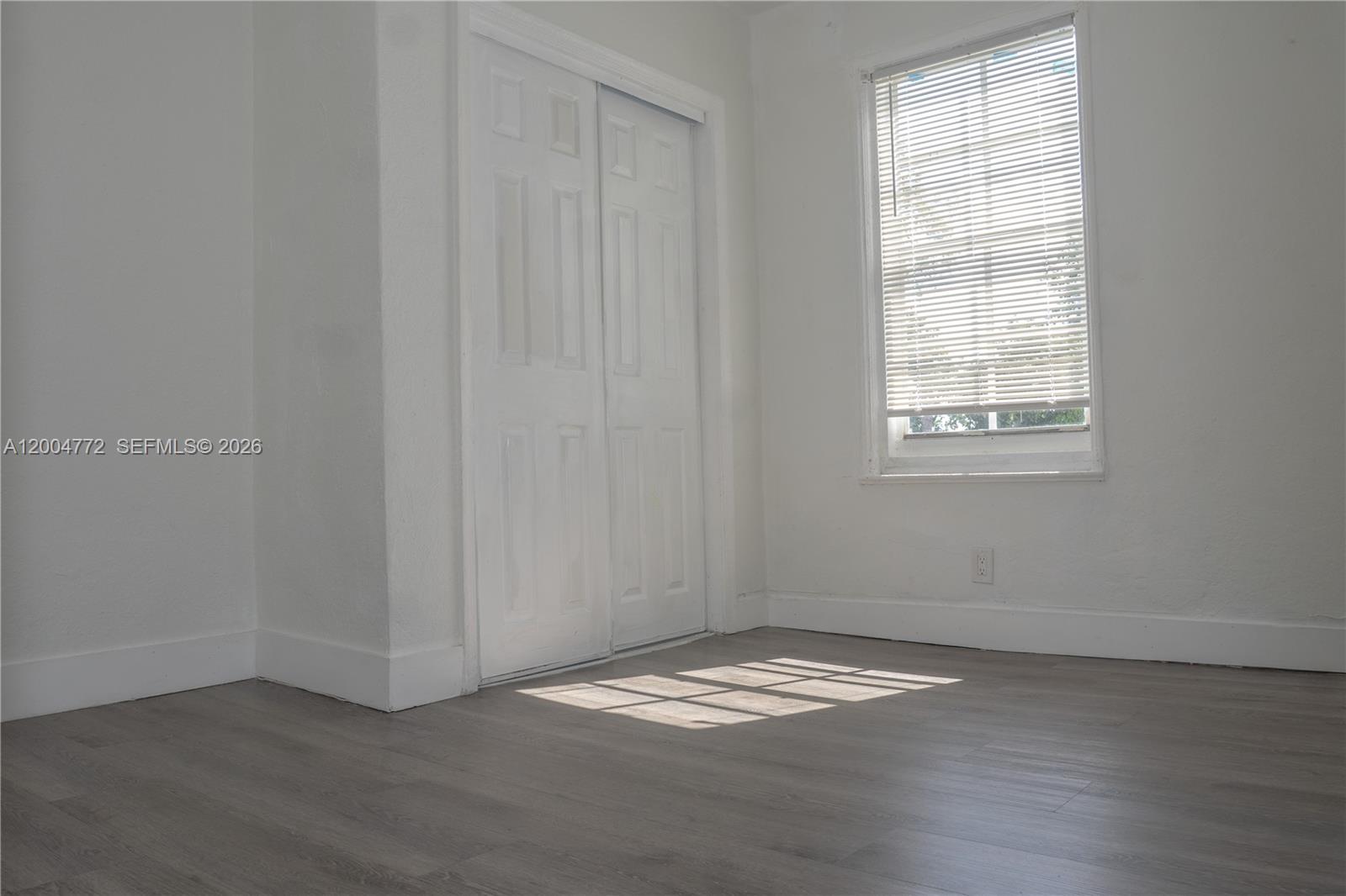 3376 Northwest 49th Street Miami, FL 33142 - Photo 9 of 17 an empty room with a window