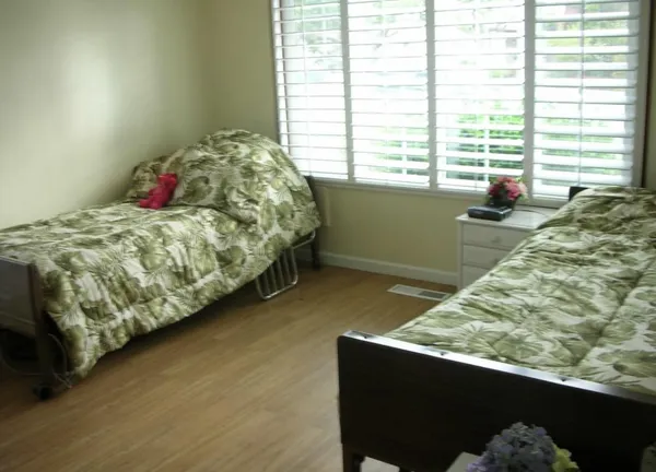 a bed sitting in a bedroom next to a window