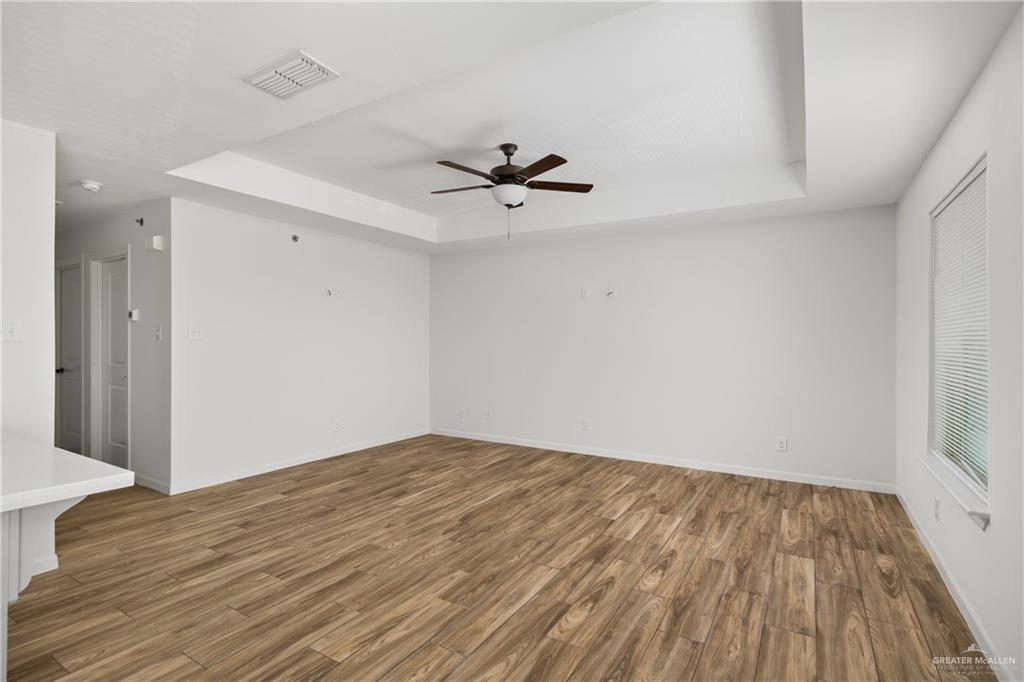 524 King Road, Unit 10 San Juan, TX 78589 - Photo 5 of 12 wooden floor in an empty room with a window