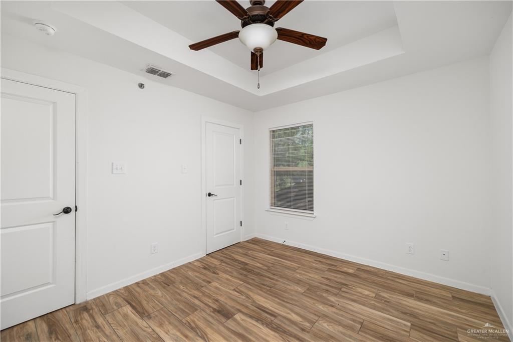 524 King Road, Unit 10 San Juan, TX 78589 - Photo 7 of 12 wooden floor in an empty room with a window