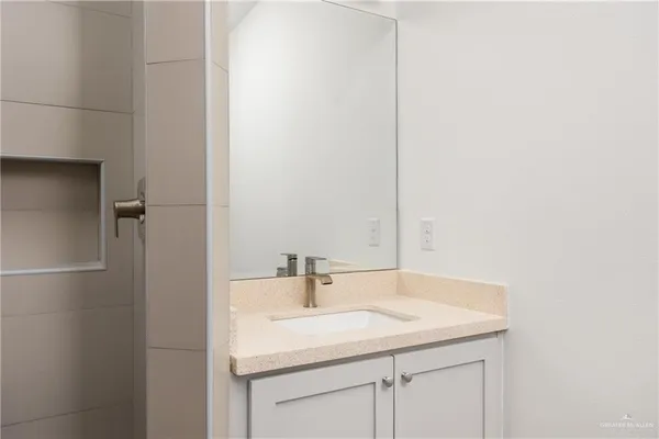 a bathroom with a sink and a mirror