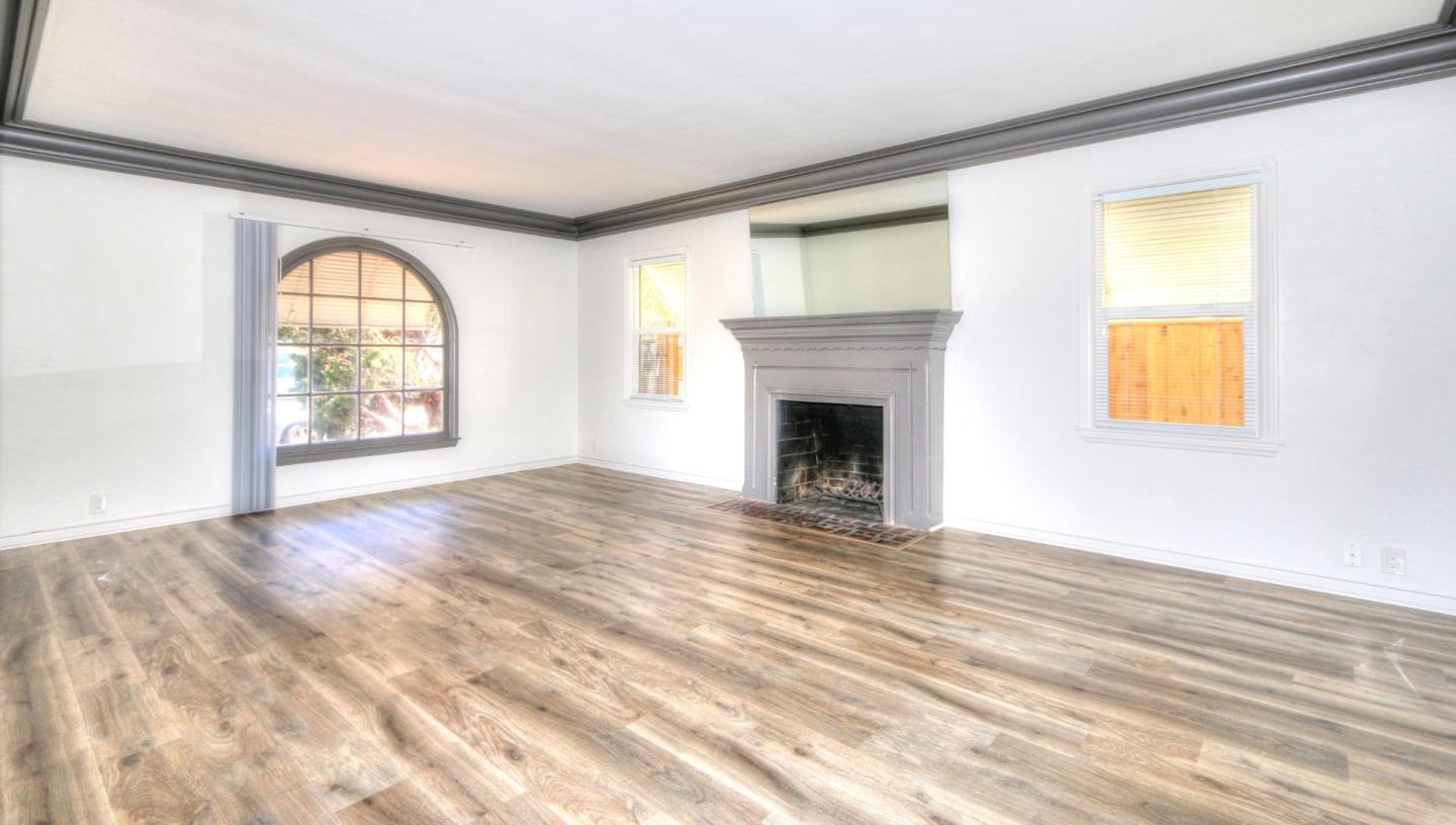 553 Rutland Avenue San Jose, CA 95128 - Photo 5 of 20 a view of an empty room with a window and wooden floor
