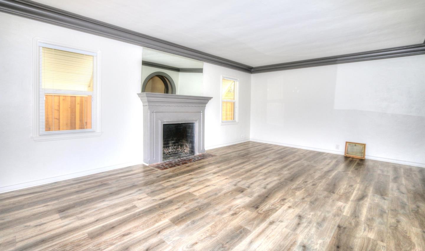 553 Rutland Avenue San Jose, CA 95128 - Photo 6 of 20 a view of empty room with a fireplace and wooden floor