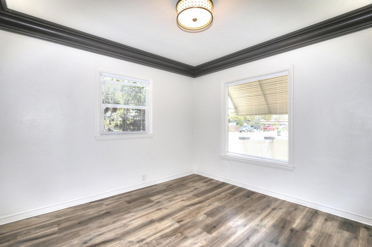 553 Rutland Avenue San Jose, CA 95128 - Photo 7 of 20 a view of empty room with window and wooden floor