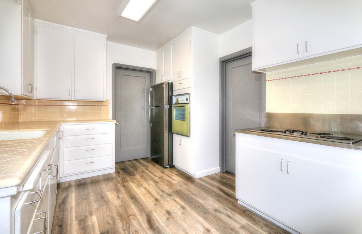 553 Rutland Avenue San Jose, CA 95128 - Photo 8 of 20 a kitchen with a refrigerator and a stove