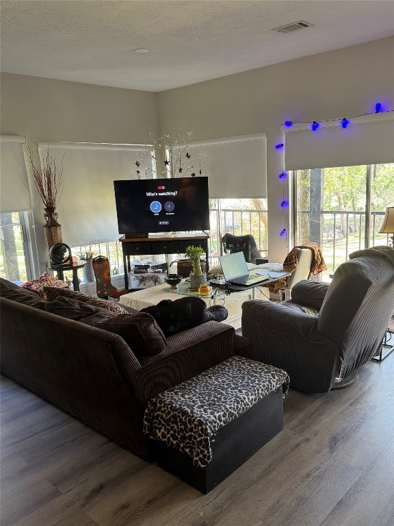 1425 April Villas Conroe, TX 77356 - Photo 12 of 21 a living room with furniture a flat screen tv and a large window