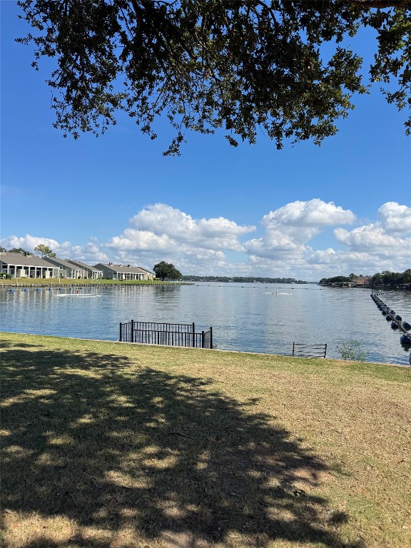 1425 April Villas Conroe, TX 77356 - Photo 18 of 21 a view of a lake with houses in the background