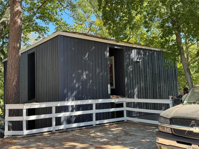 a house with a trees in the background