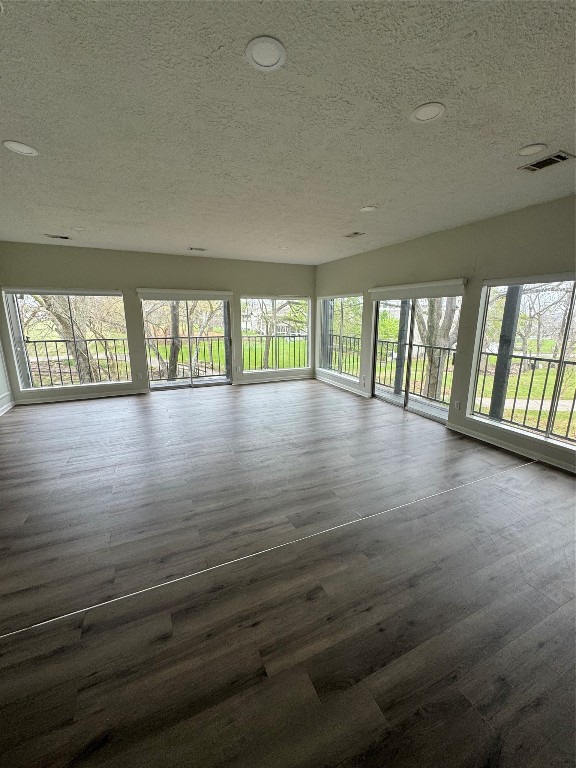 1425 April Villas Conroe, TX 77356 - Photo 7 of 21 wooden floor in an empty room with a window