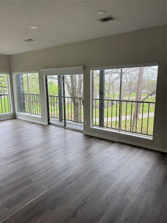 1425 April Villas Conroe, TX 77356 - Photo 8 of 21 wooden floor in an empty room with a window
