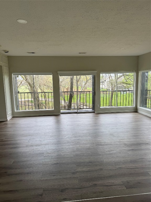 1425 April Villas Conroe, TX 77356 - Photo 9 of 21 wooden floor in an empty room with a window