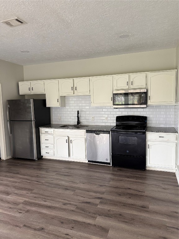 1425 April Villas Conroe, TX 77356 - Photo 10 of 21 a kitchen with stainless steel appliances granite countertop a stove a sink and a refrigerator