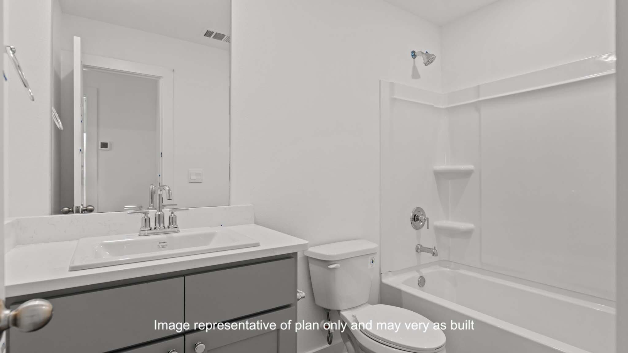 617 East 15th Street Wolfforth, TX 79382 - Photo 12 of 33 a bathroom with a sink toilet vanity and bathtub