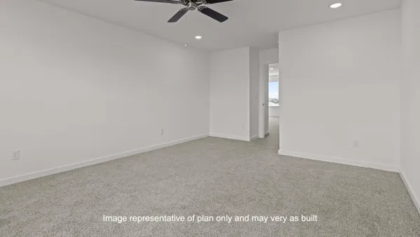 a view of a room with a ceiling fan