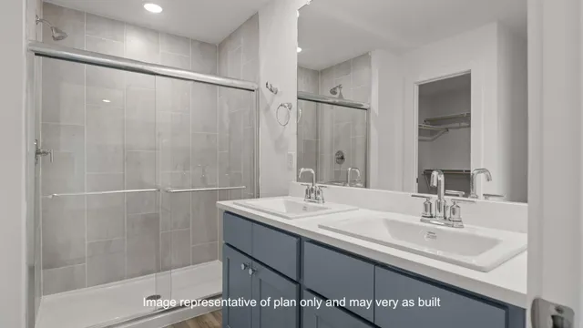 a bathroom with a sink double vanity and shower