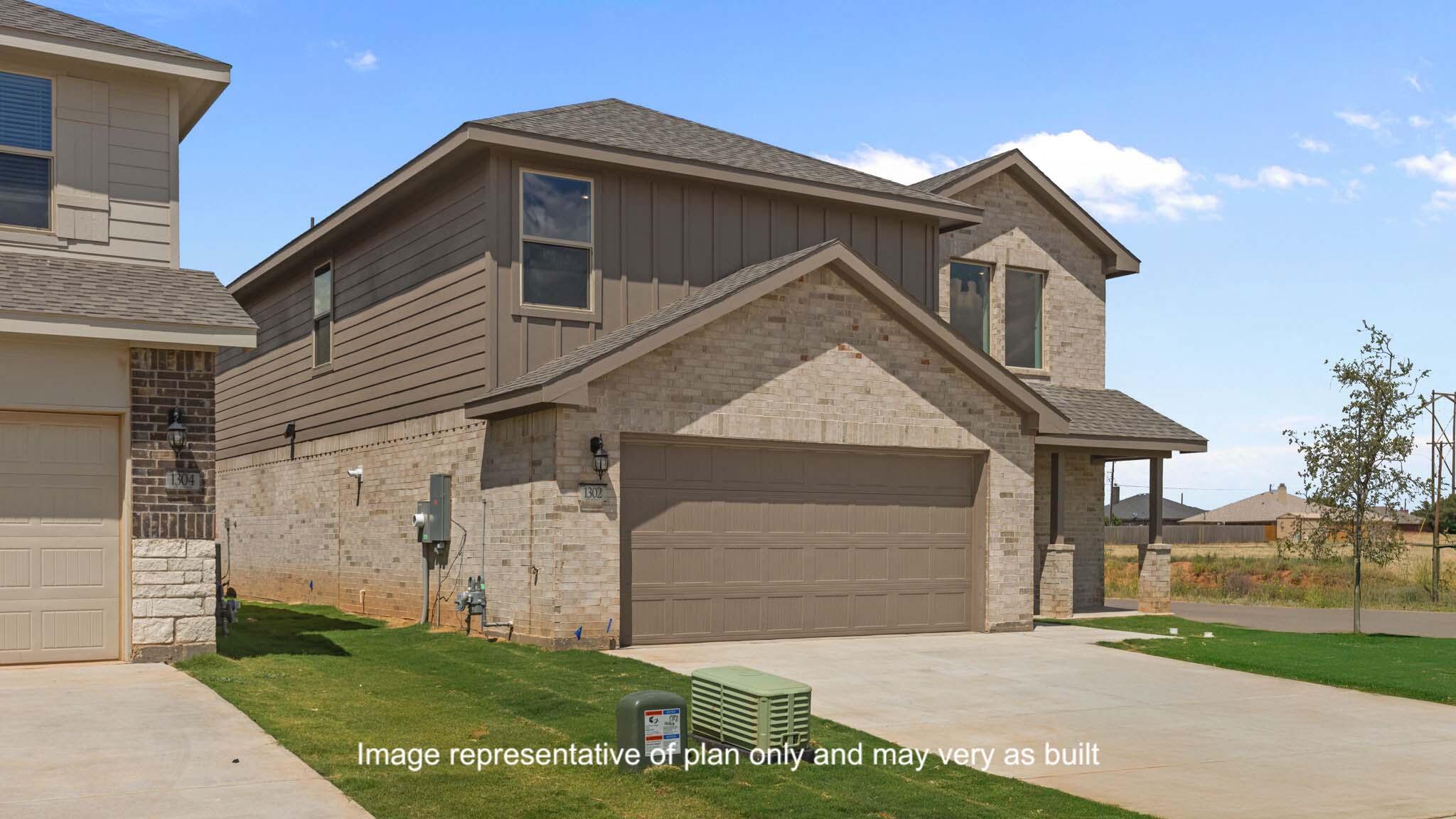 617 East 15th Street Wolfforth, TX 79382 - Photo 2 of 33 a front view of a house with a yard and garage