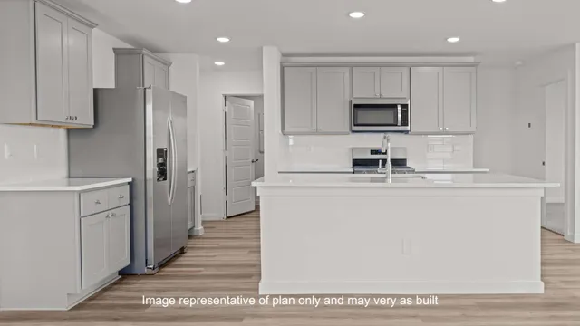 a kitchen with kitchen island a sink stainless steel appliances and cabinets