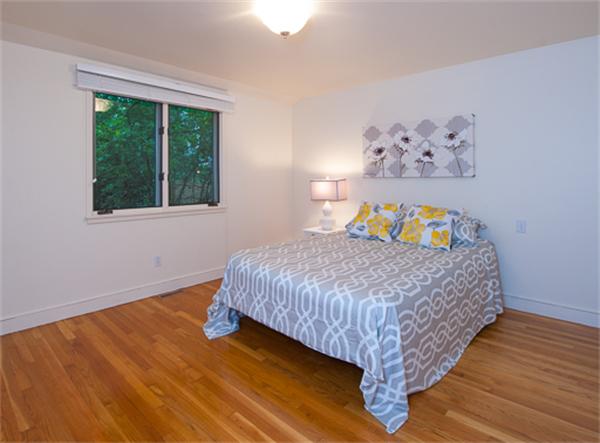 15 Oakvale Road Newton, MA 02468 - Photo 13 of 23 a bed sitting in a bedroom next to a window