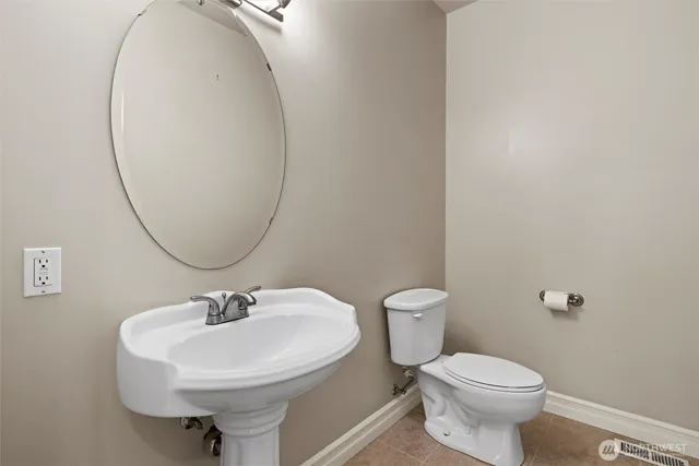 a bathroom with a sink a mirror and a toilet