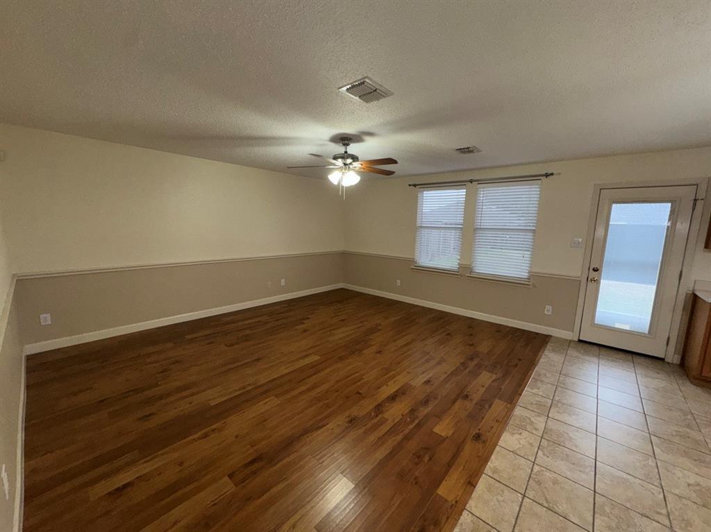 2024 Brazos Court Grand Prairie, TX 75052 - Photo 11 of 40 wooden floor in an empty room with a window