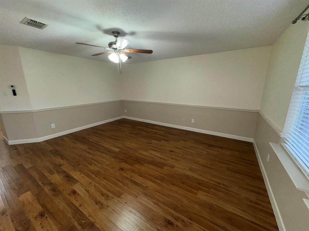 2024 Brazos Court Grand Prairie, TX 75052 - Photo 17 of 40 wooden floor in an empty room with a window