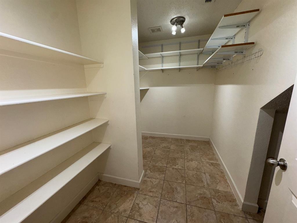 2024 Brazos Court Grand Prairie, TX 75052 - Photo 19 of 40 a view of walk in closet with empty racks