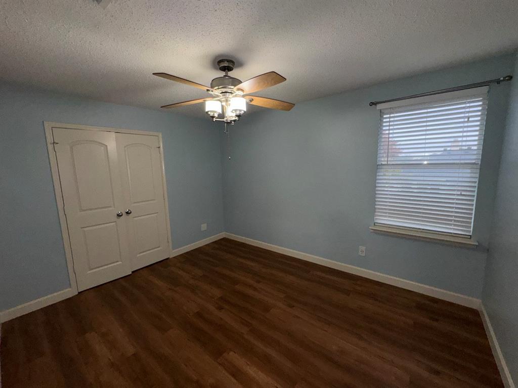 2024 Brazos Court Grand Prairie, TX 75052 - Photo 25 of 40 a view of an empty room with wooden floor and a window