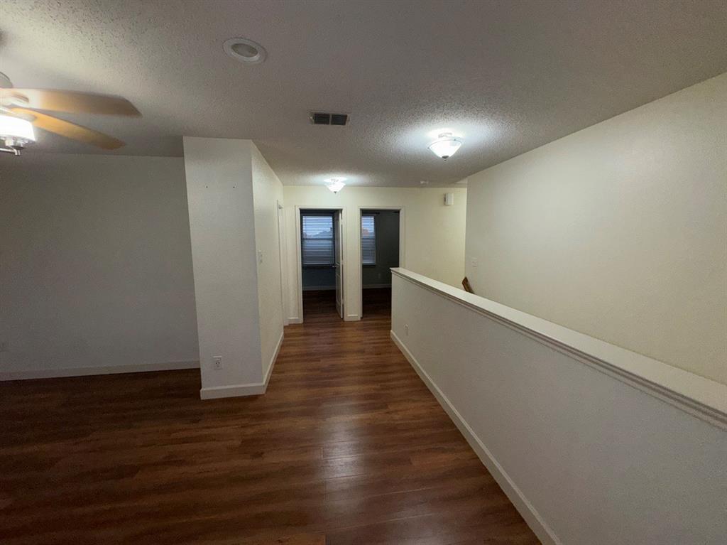 2024 Brazos Court Grand Prairie, TX 75052 - Photo 30 of 40 a view of a hallway with wooden floor