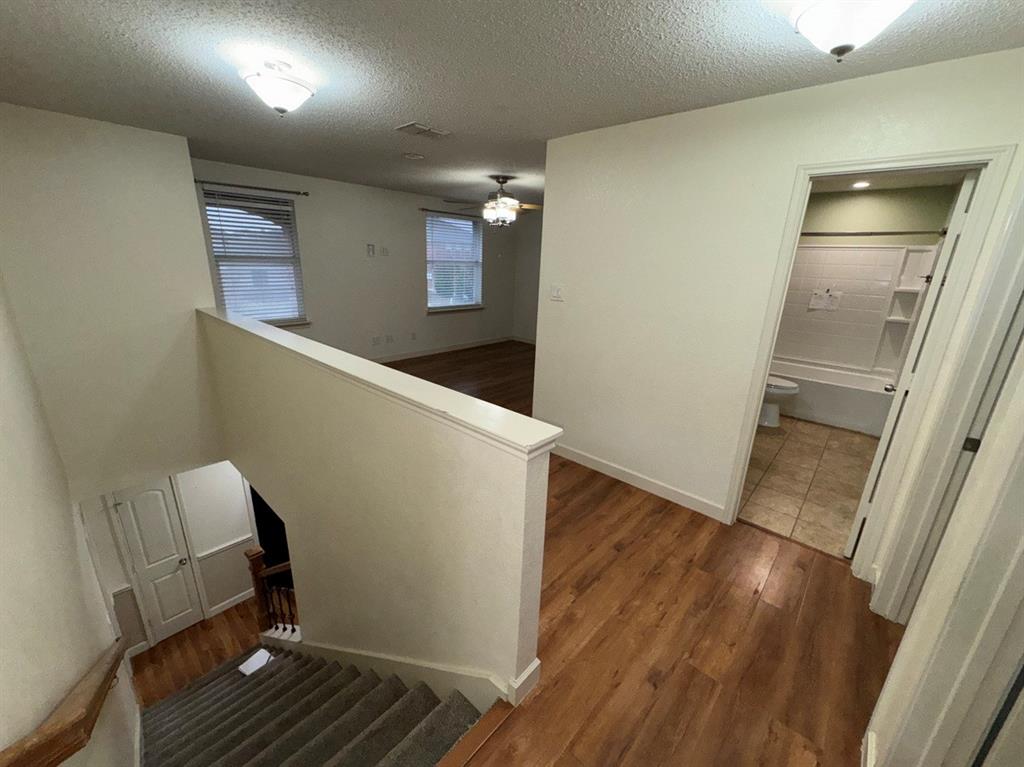 2024 Brazos Court Grand Prairie, TX 75052 - Photo 31 of 40 a view of a livingroom with wooden floor and staircase