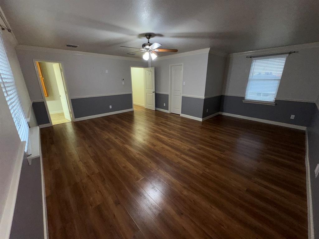2024 Brazos Court Grand Prairie, TX 75052 - Photo 34 of 40 a view of an empty room with wooden floor and a window