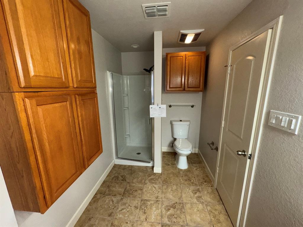 2024 Brazos Court Grand Prairie, TX 75052 - Photo 39 of 40 a view of a hallway with wooden floor and bathroom view