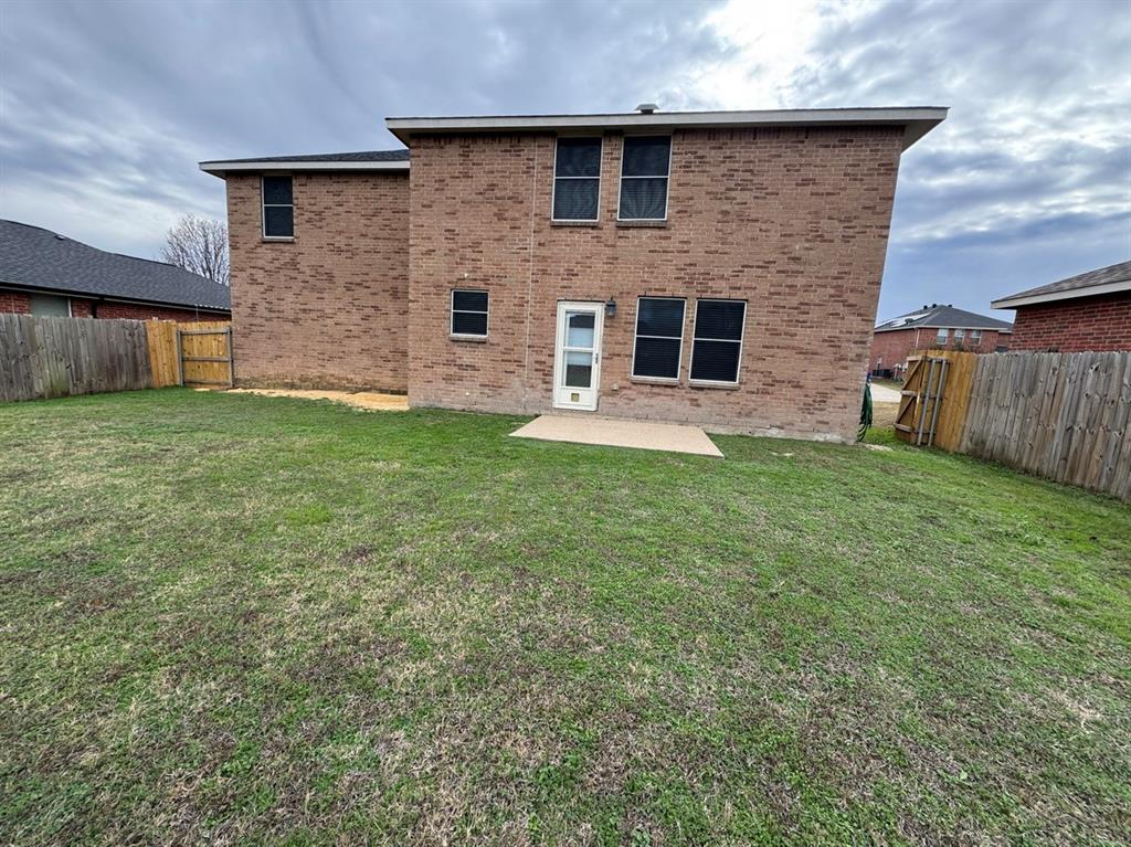 2024 Brazos Court Grand Prairie, TX 75052 - Photo 5 of 40 a brick house with a yard