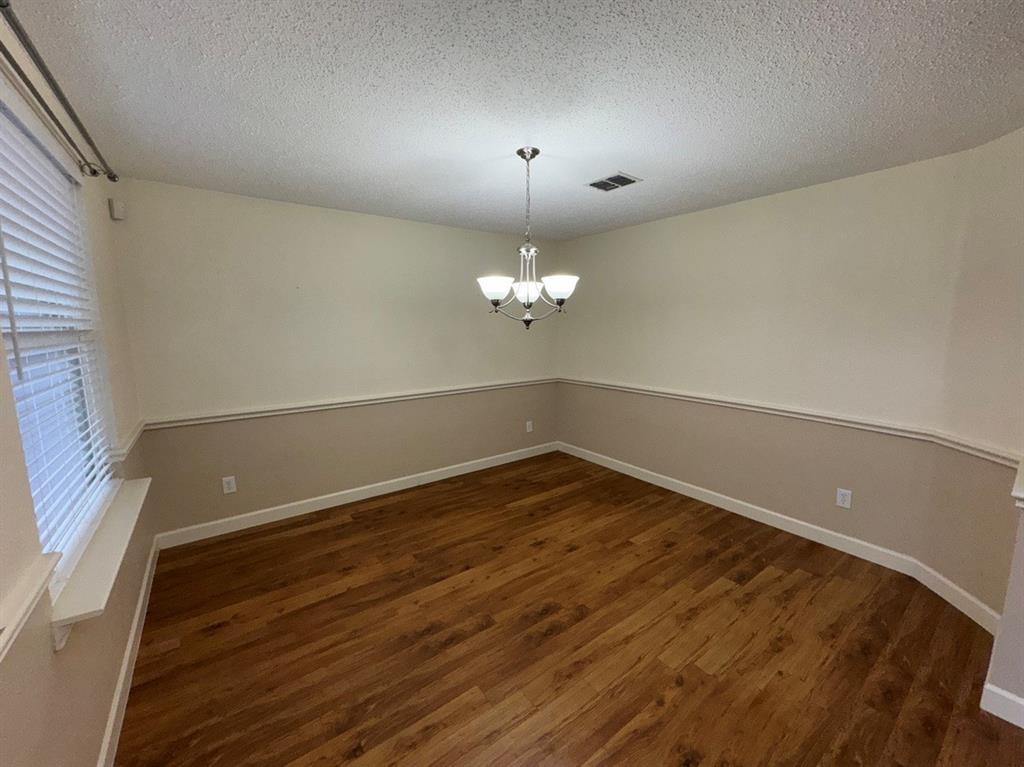 2024 Brazos Court Grand Prairie, TX 75052 - Photo 6 of 40 a view of a room with wooden floor and ceiling fan