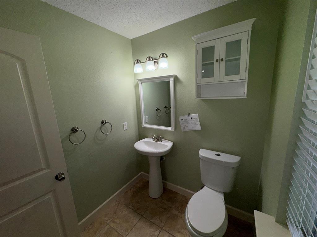 2024 Brazos Court Grand Prairie, TX 75052 - Photo 10 of 40 a bathroom with a toilet sink and shower