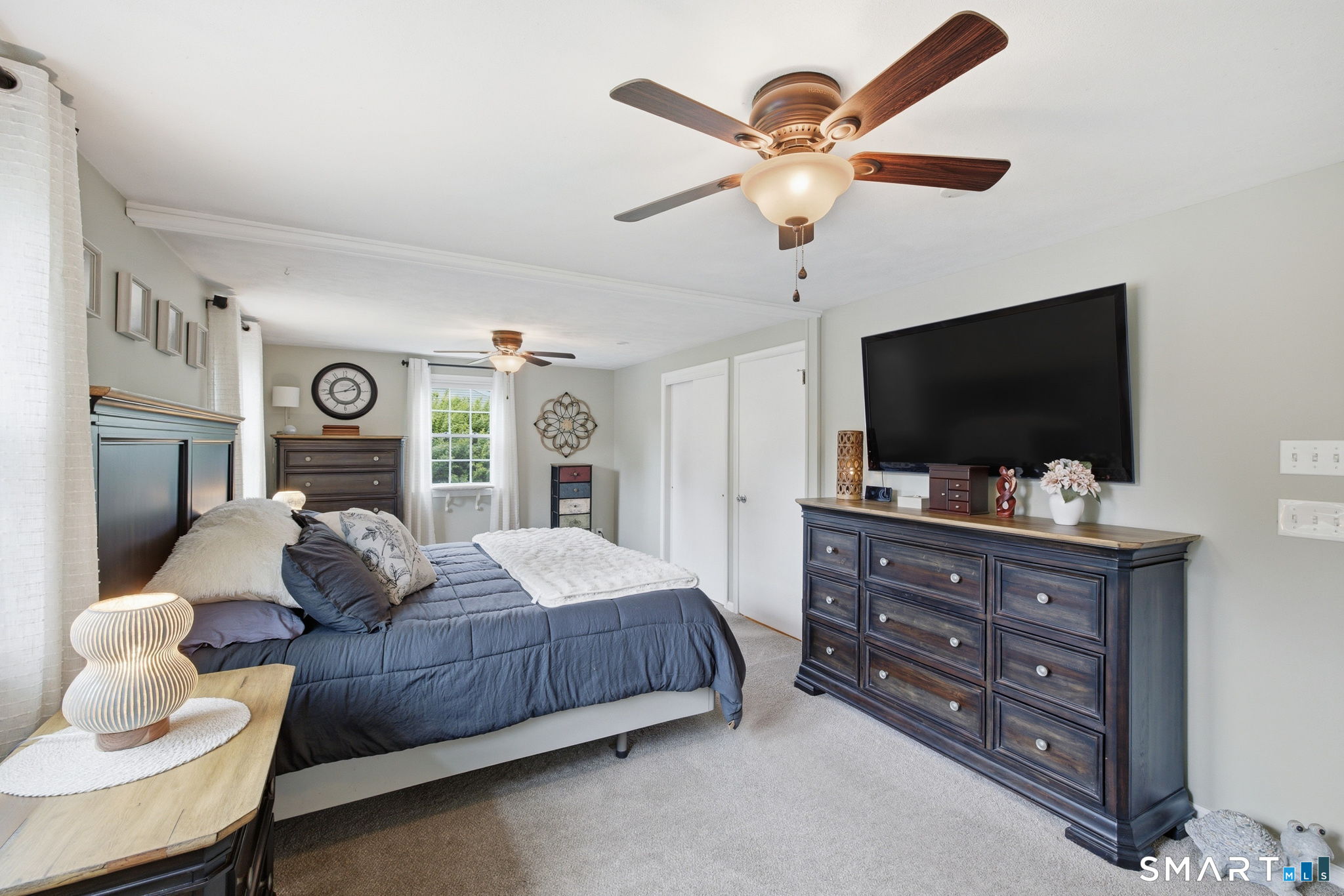 7 Stardust Drive Enfield, CT 06082 - Photo 12 of 38 a bedroom with a bed and a flat screen tv