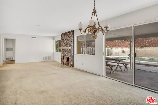a view of a room with window and chandelier