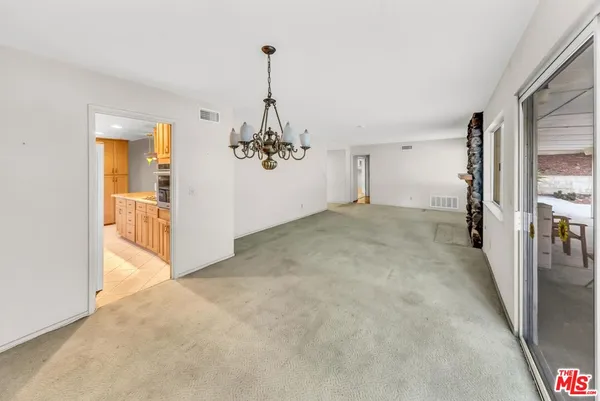 a view of a room with a sink and refrigerator
