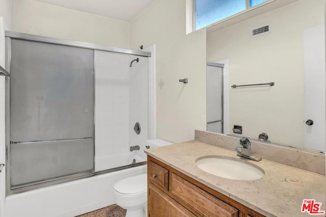 11258 Yolanda Avenue Porter Ranch, CA 91326 - Photo 38 of 46 a bathroom with a granite countertop sink toilet and shower