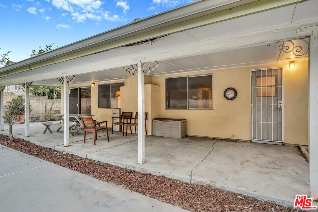 11258 Yolanda Avenue Porter Ranch, CA 91326 - Photo 41 of 46 a view of a patio with table and chairs and potted plants