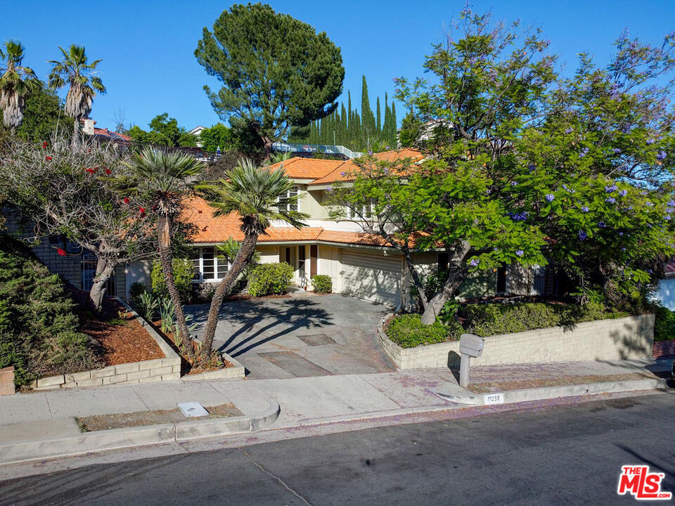 11258 Yolanda Avenue Porter Ranch, CA 91326 - Photo 9 of 46 a view of a bench in the middle of a yard